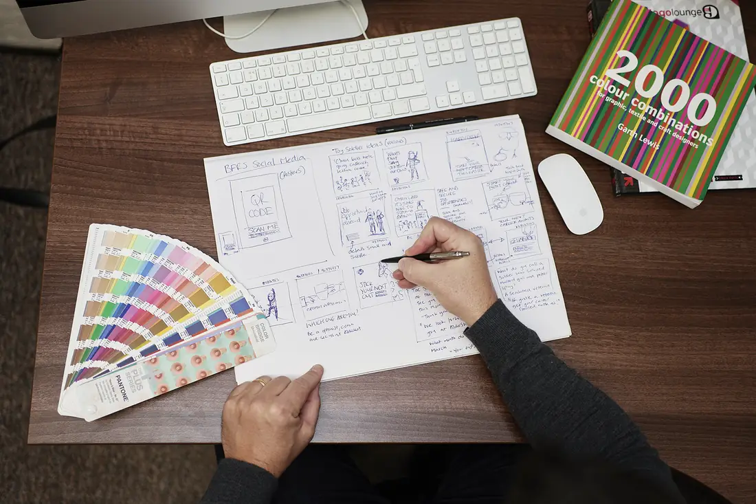Steve sketching campaign ideas beside a Pantone fan